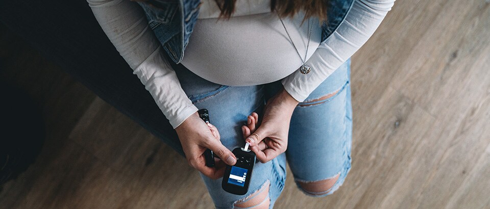 Pregnant woman checking blood sugar