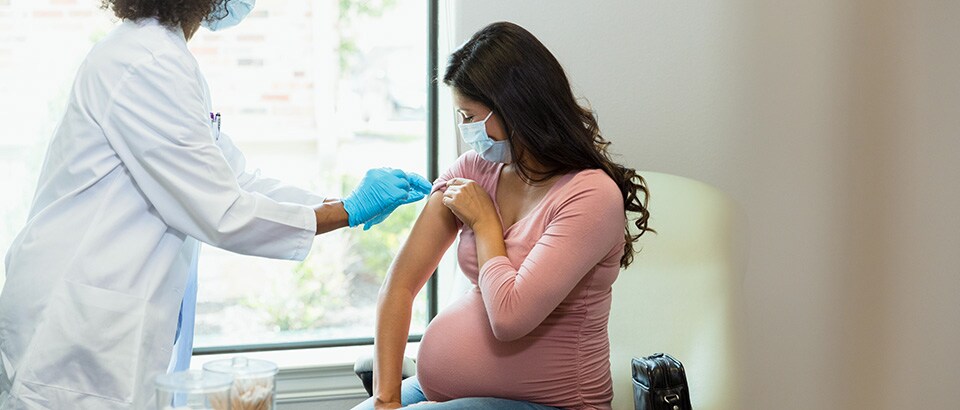 Pregnant woman being vaccinated