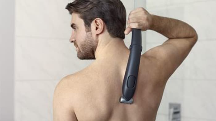 Body groomer with back shaving attachment